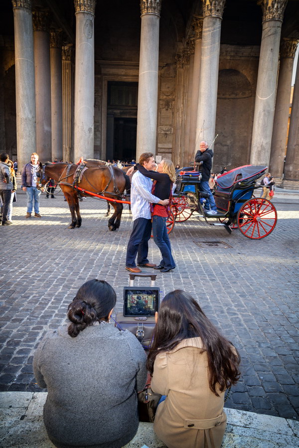 photo-tour-02-2312 Couple romantically in love. Pantheon. While tourists watch tv waiting.