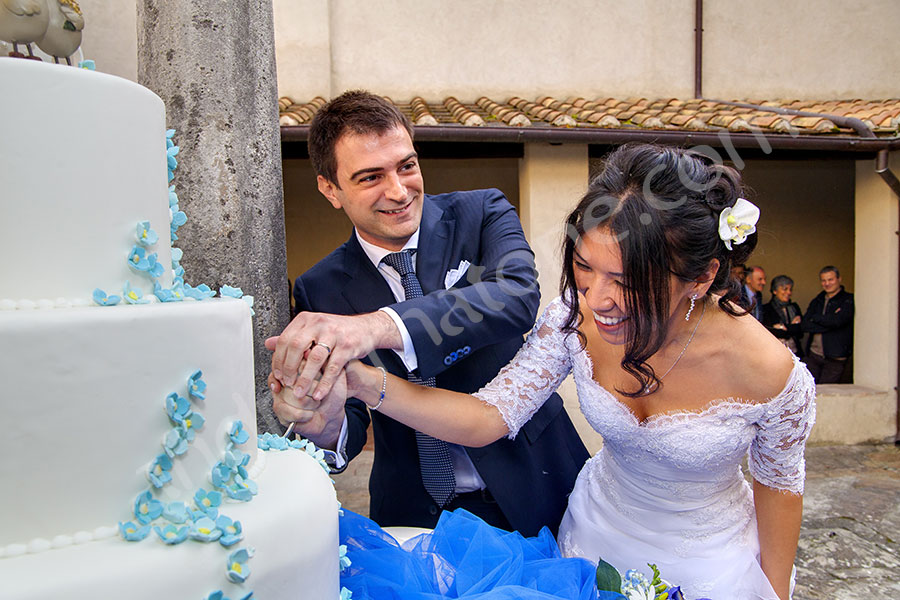 wedding-italy-81-1412 Bride and groom having a hard time cutting the cake