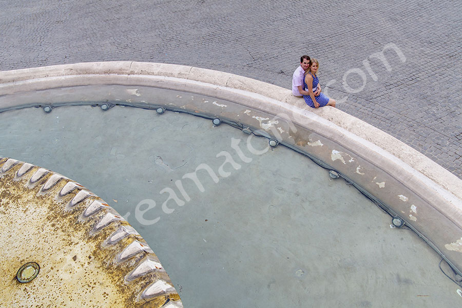 proposal-rome-6712-035 Sitting by a water fountain and looking up in Piazza del Popolo