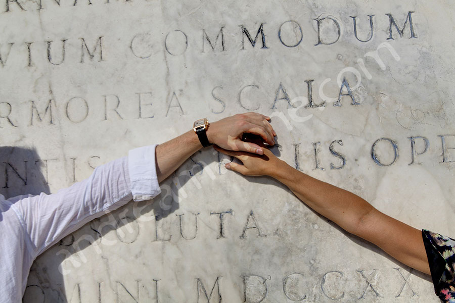 photographer-rome-1912-039 Holding onto each other's arms in front of marble slab
