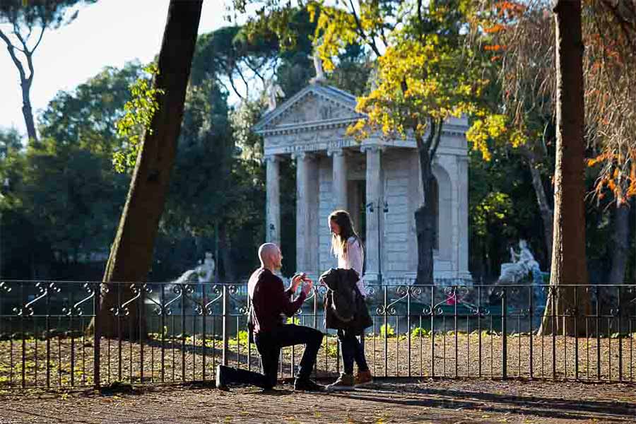 Man asking for marriage. Villa Borghese lake. In front of an ancient roman temple