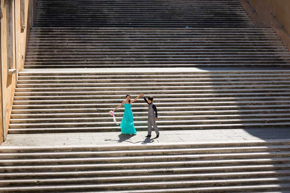 Pre wedding matrimonial photo session. Standing on stairs. Stepping down.