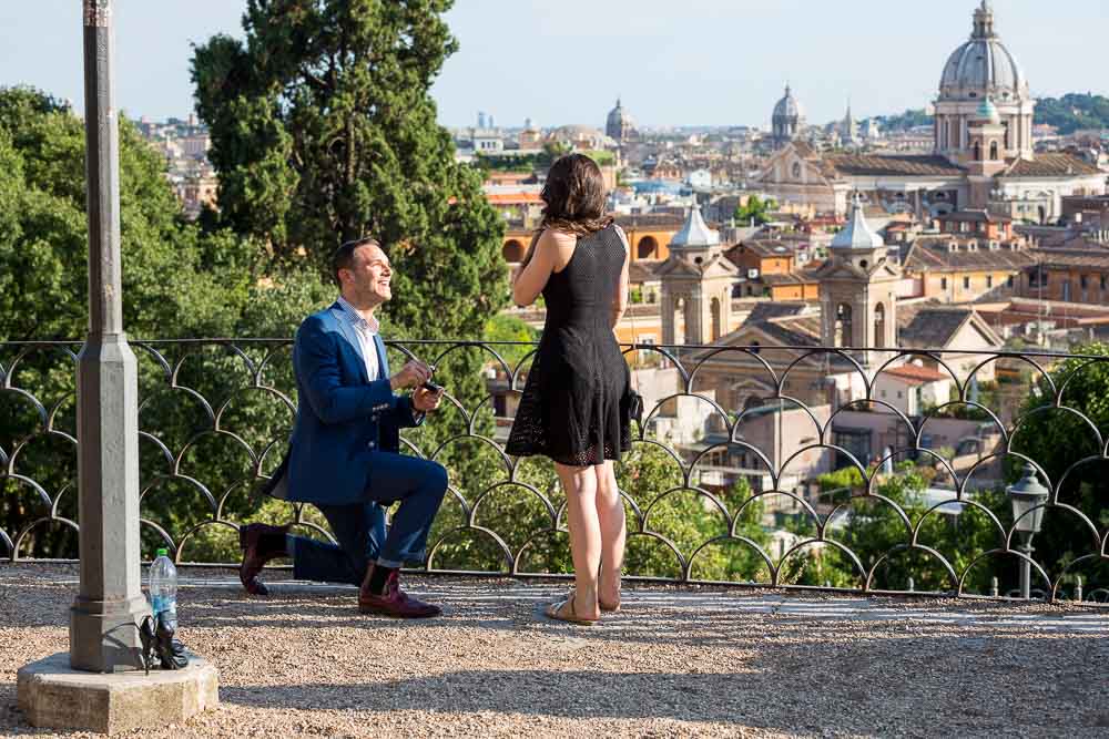 Man proposing to his girlfriend in Rome at a beautiful location. romantic secret proposal.