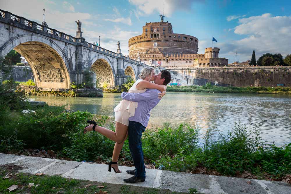 Jumping for joy at the Castel Sant'Angelo Tiber river bank in Rome Italy