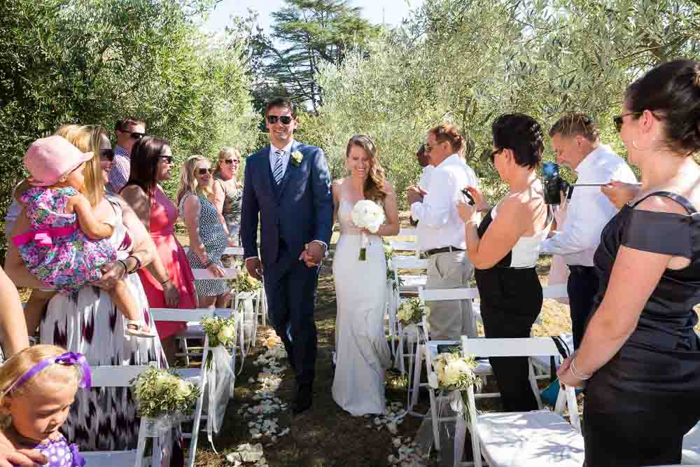 Groom & bride entering the marriage venue. Wedding Photography in Pisa as Destination