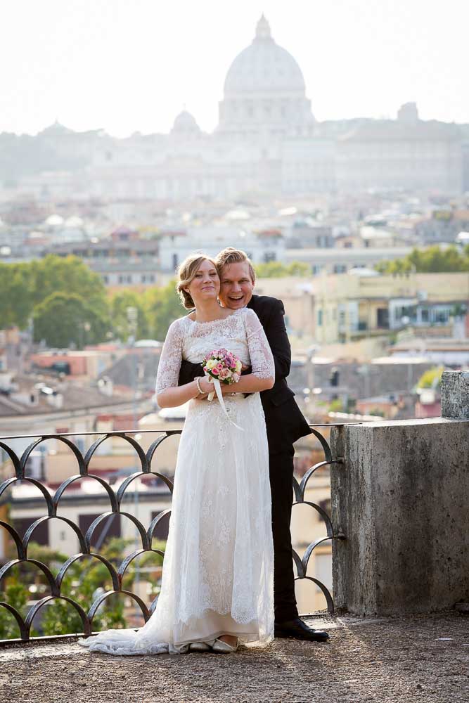 Posed picture before the roman panoramic view leading into Saint Peter's dome far distance
