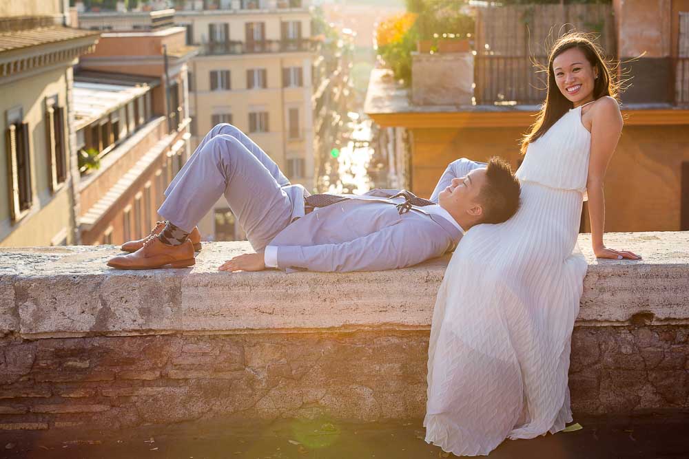 Photo shooting in Rome. Engagement photos taken by a professional photographer from Italy overlooking the rooftops at sunset
