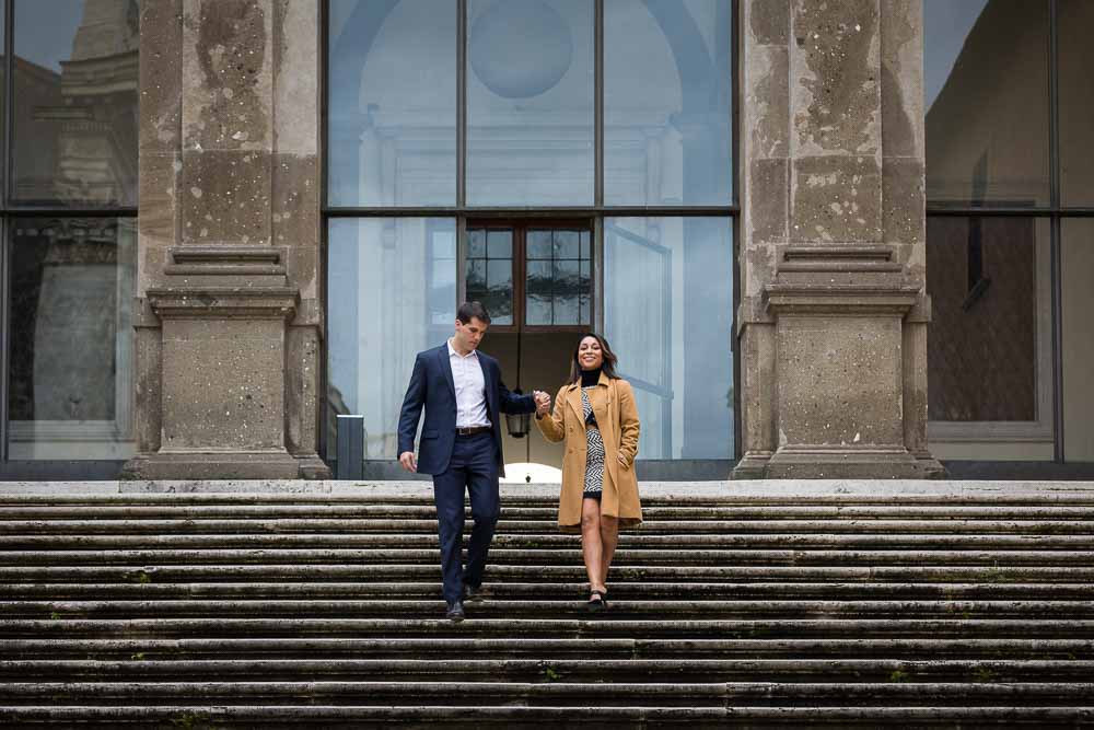 Couple descending stairs while holding hands photo session