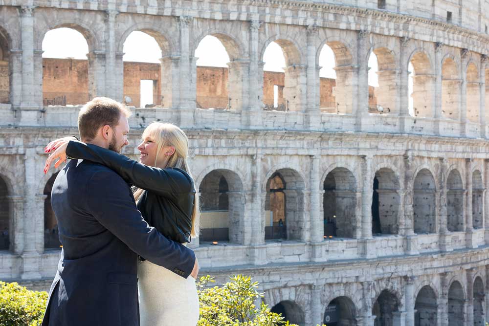 Engaged couple portrait Coliseum using a telephone lens from a distance 