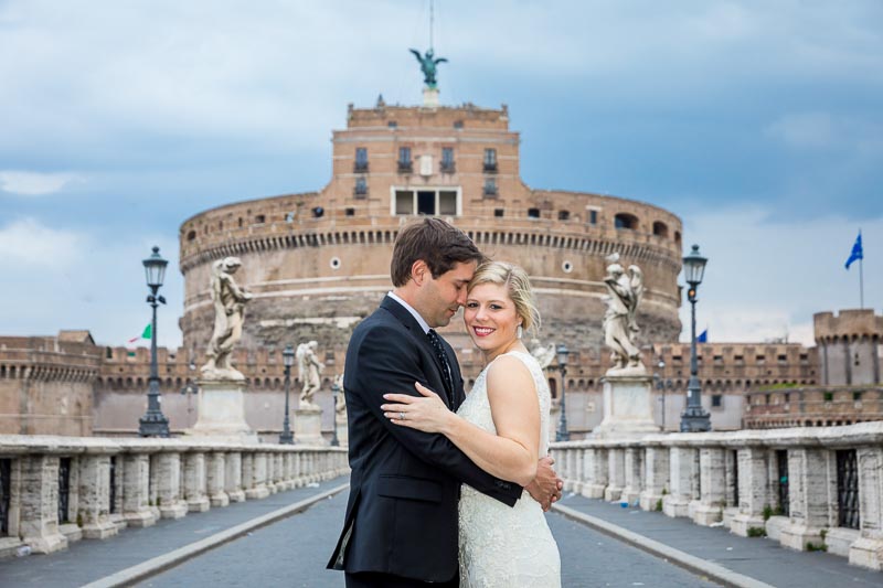 Just married taking pictures Castel Sant'Angelo bridge and castle
