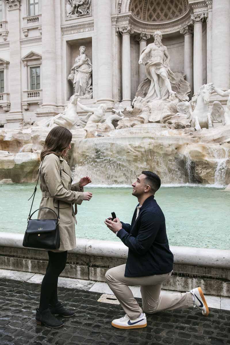 02-man-proposal Man kneeling down to ask the most important question! A romantic proposal moment photographer at the Trevi fountain