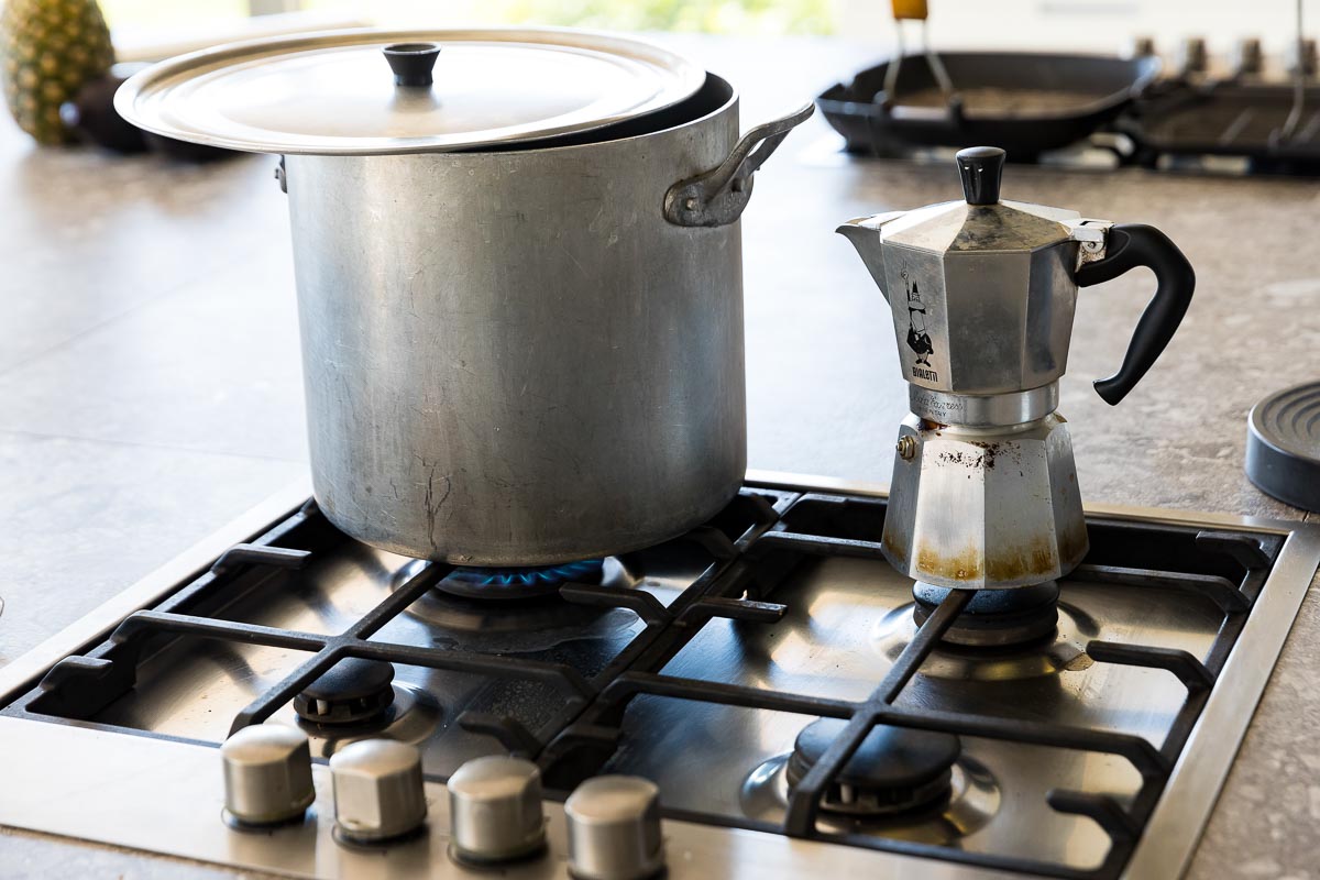 Large pan and a coffee making machine heating on the cooker