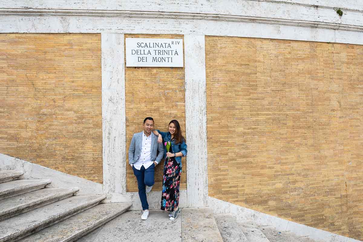 Portrait picture of a couple standing Spanish steps