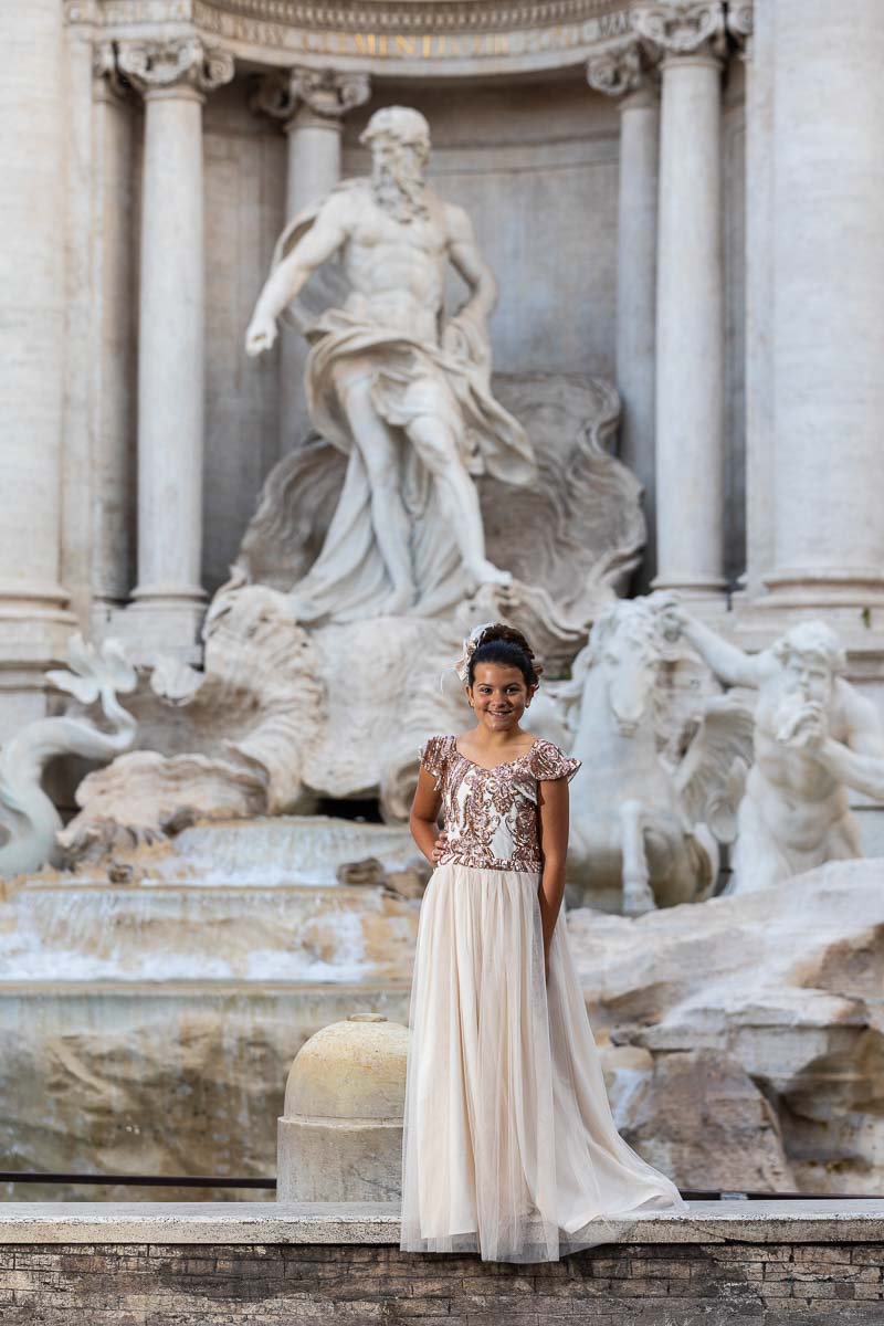 Sweet sixteen birthday photos beside the marble sculptures of the Trevi Fountain