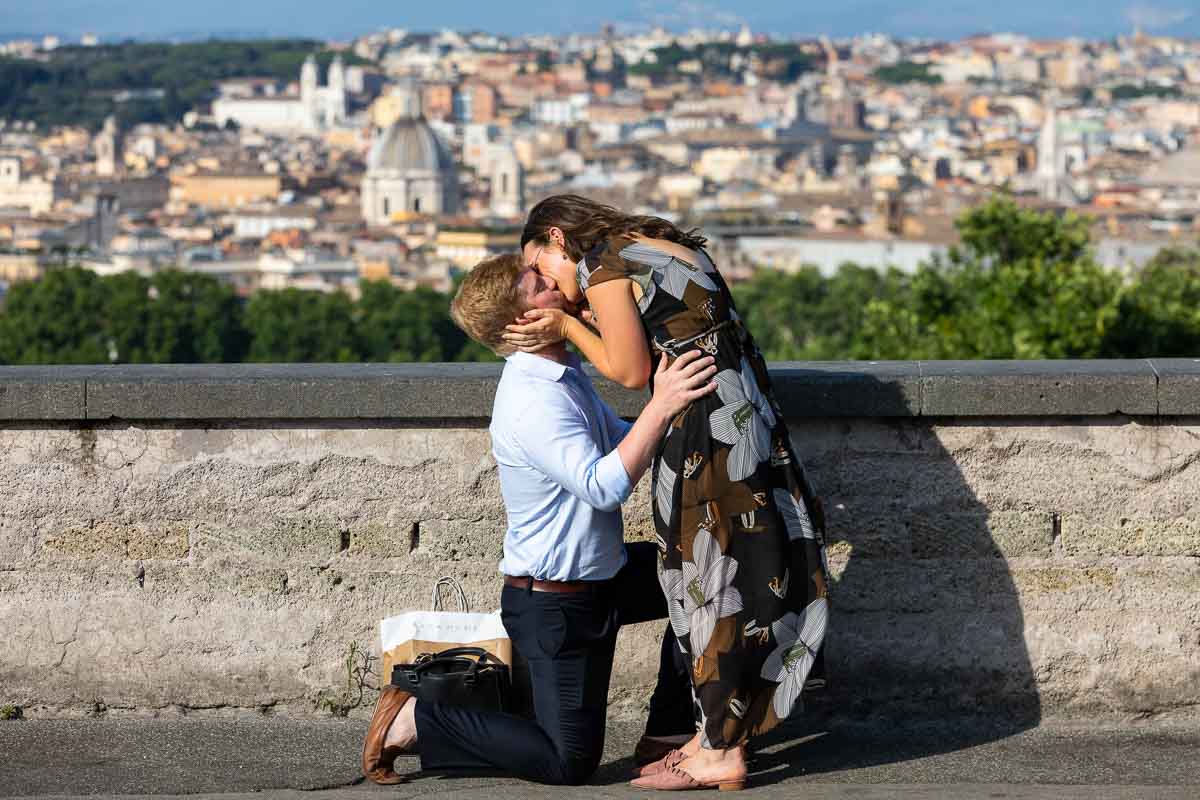 She said yes. Kissing photo of a newly engaged couple just engaged in Italy