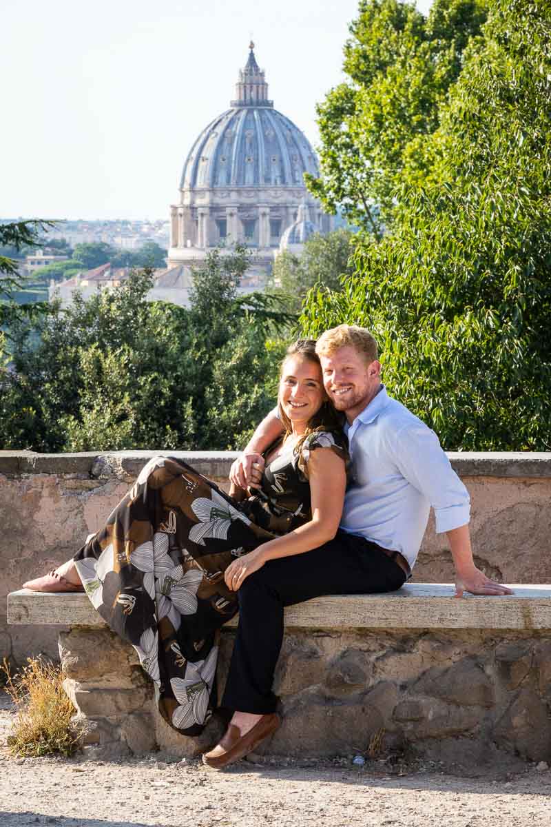 Portrait picture taking sitting down on a marble bench with St. Peter's Cathedral dome background