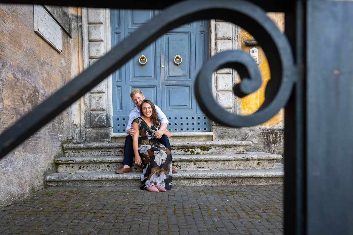 Creative portrait photography couple sitting down before a nice door