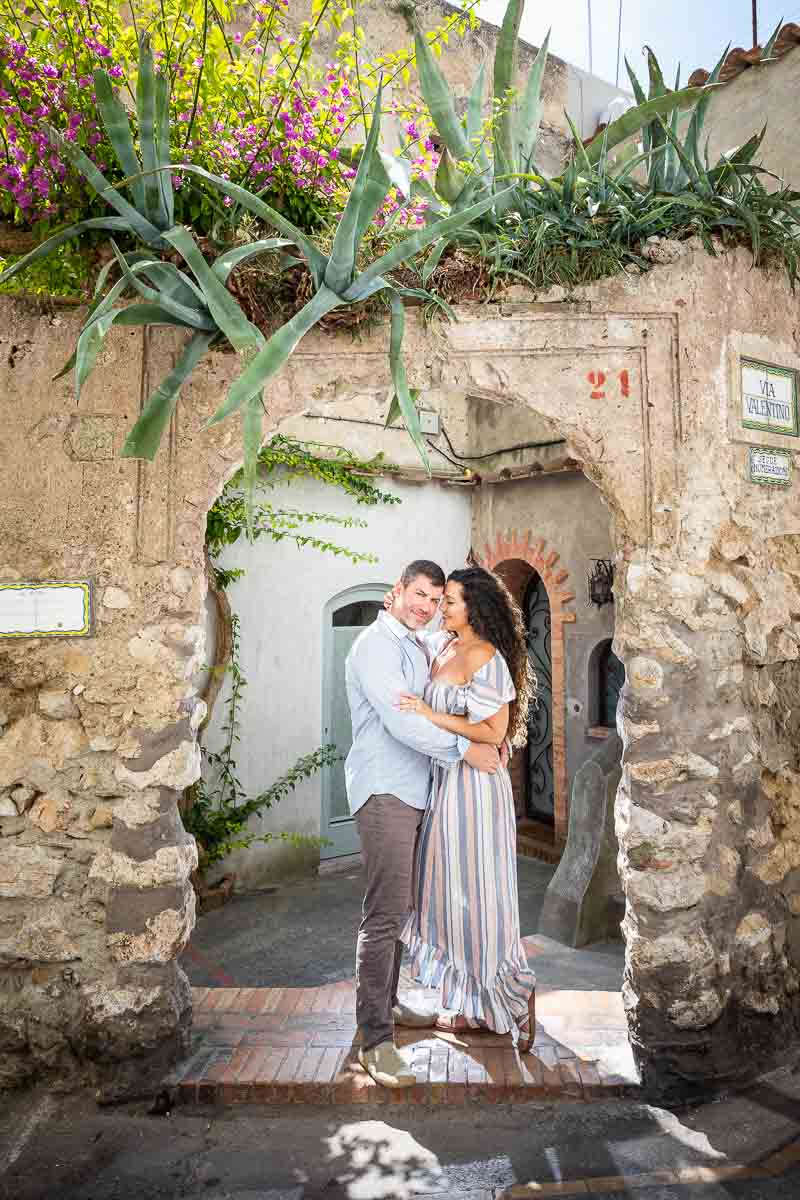 Posed portrait picture standing underneath an arc in the ancient town