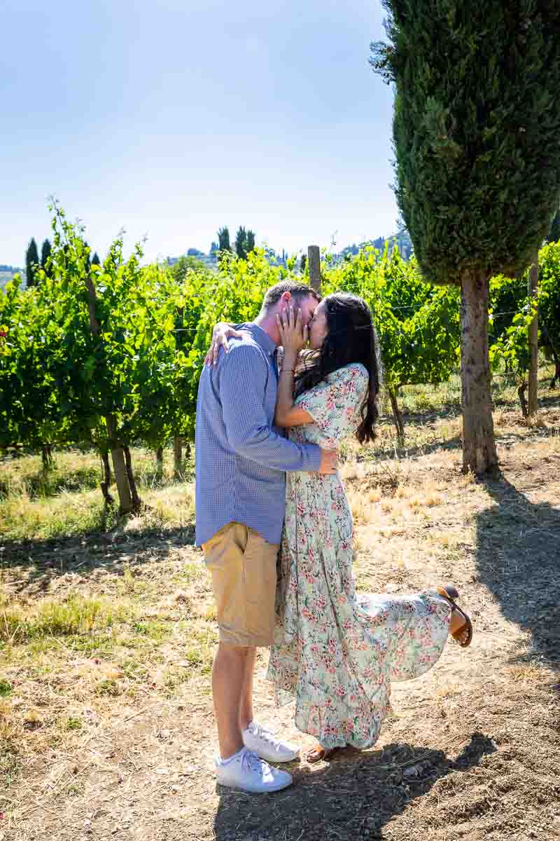 Kissing in Tuscan country in scenic typical Italian environment 