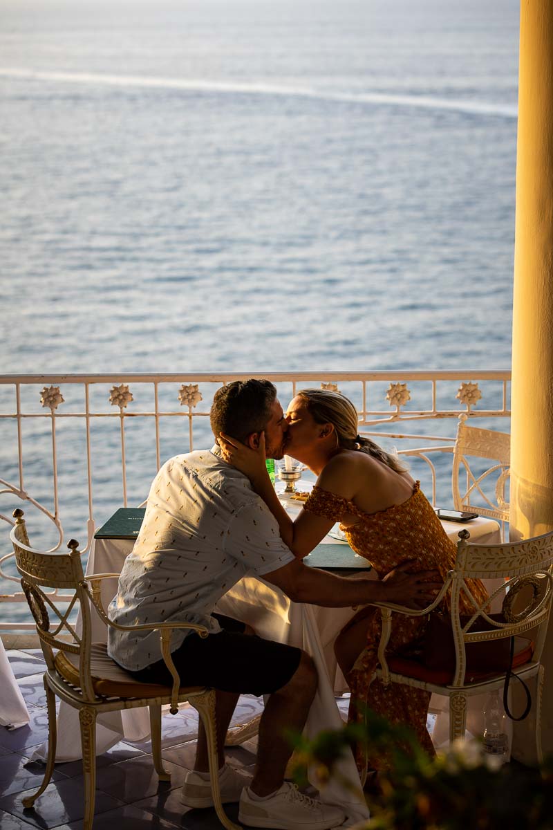 Just engaged in costiera sorrentina in Italy. Kissing by seaside view after asking the big question photoshoot