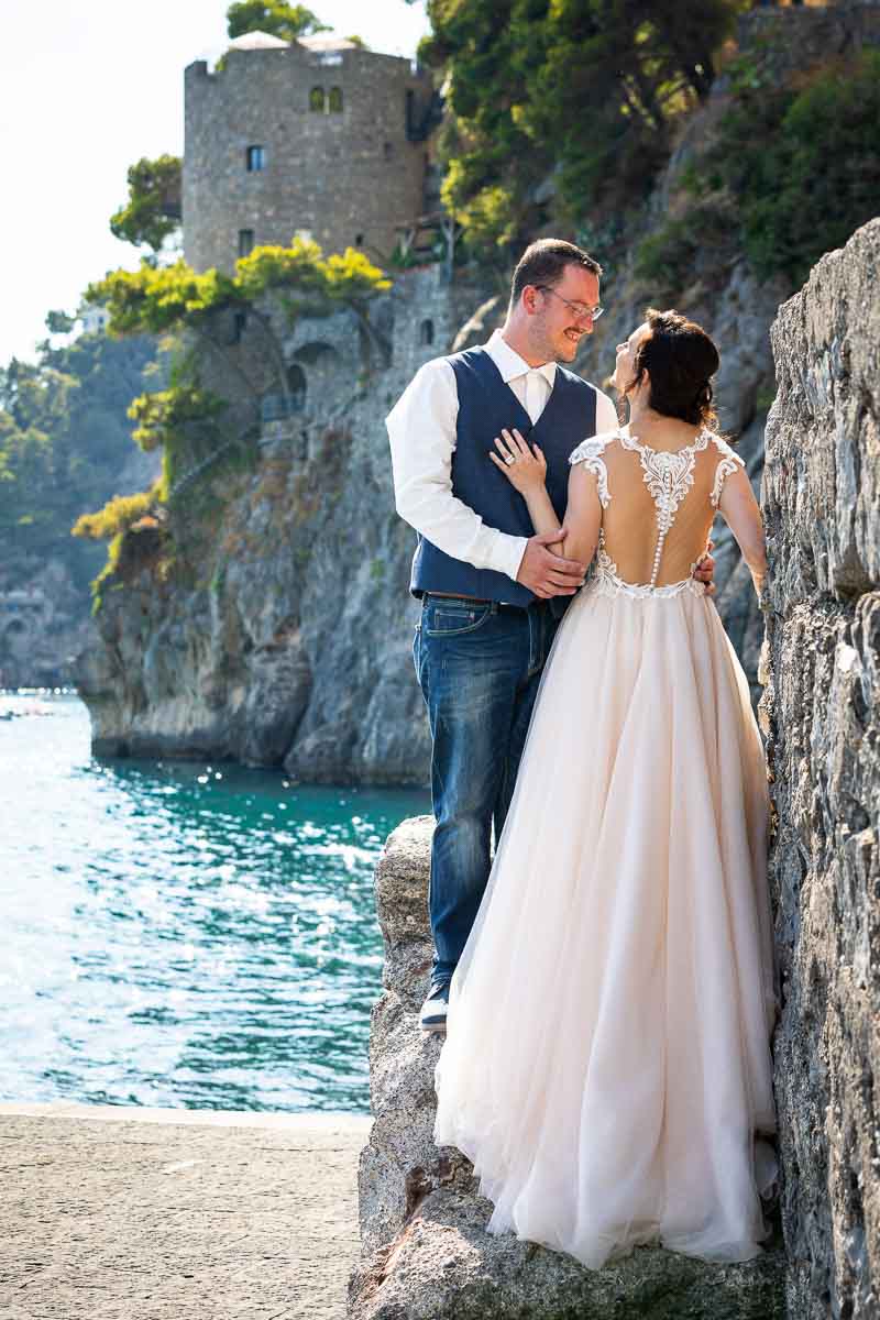 Positano bride and groom shots taken in Marina Grande with the beautiful and scenic view of the Amalfi coastline in the background