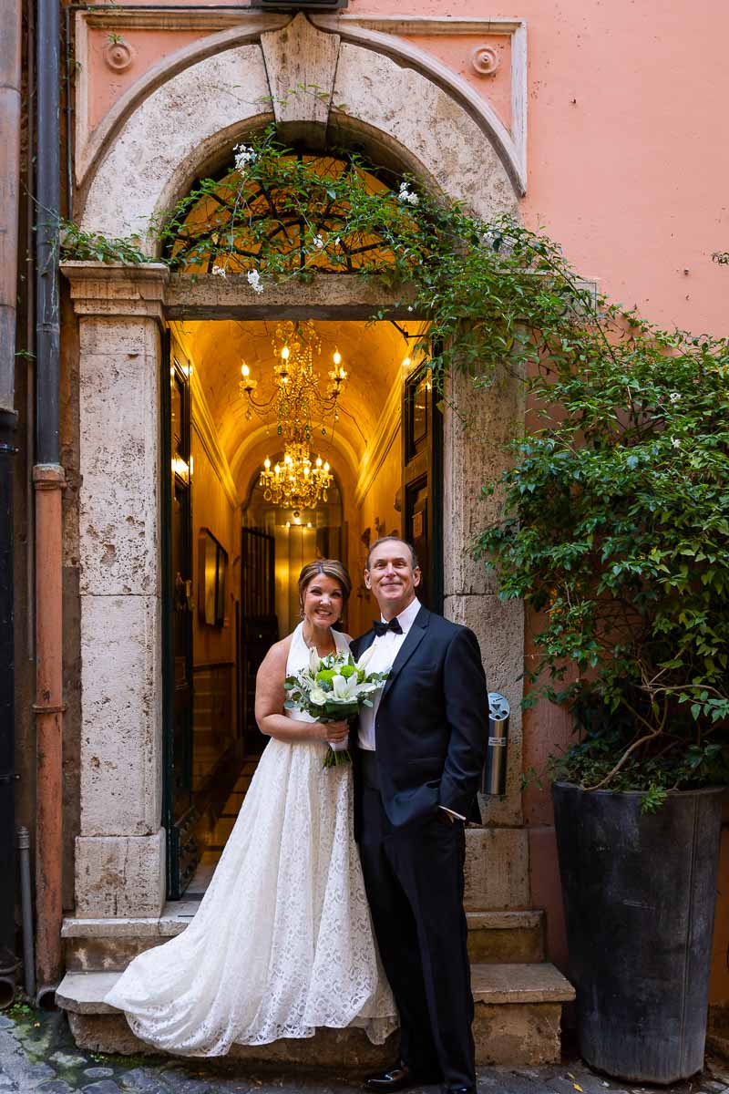 Standing outside the venue taking a portrait picture of the newlyweds