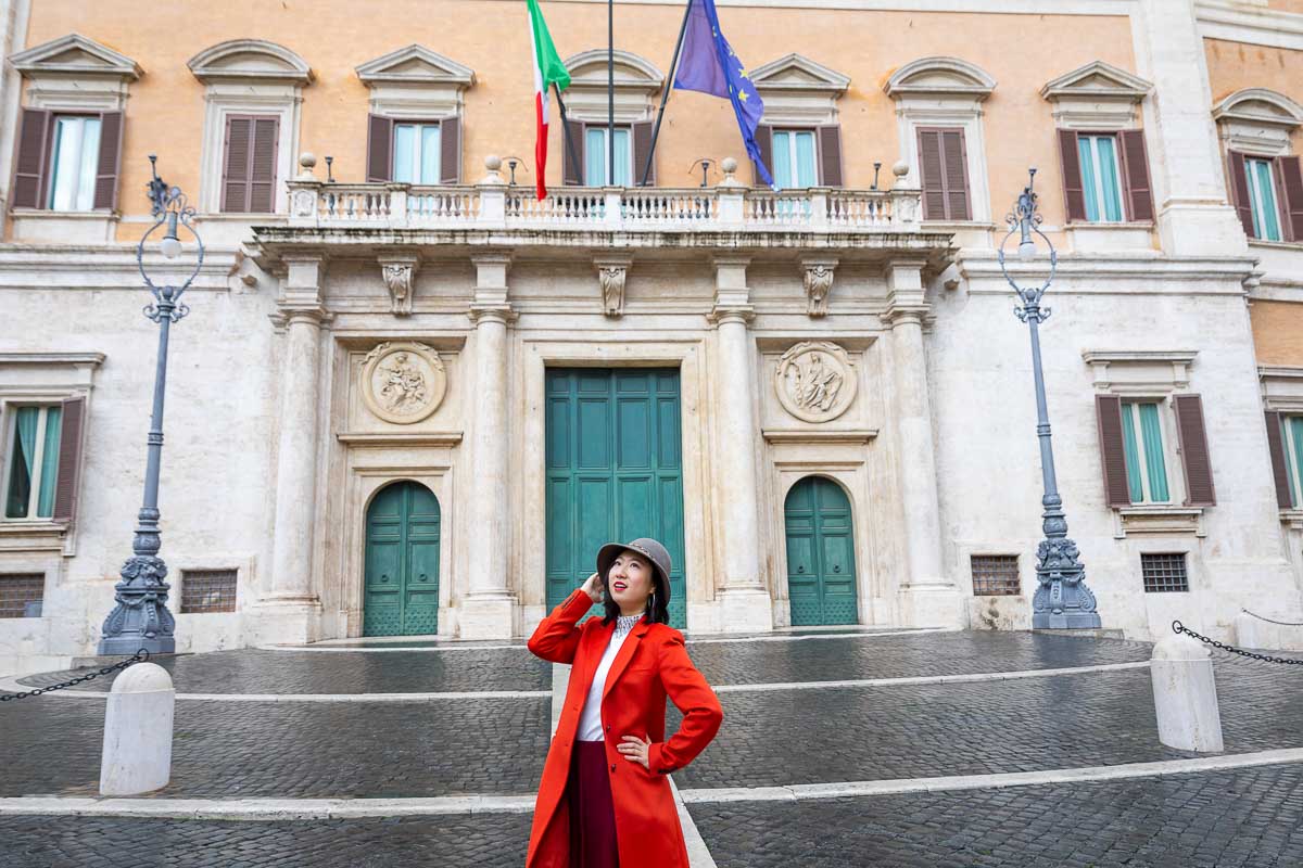 Standing in front of the Montecitorio building in Rome Italy taking fashionable pictures