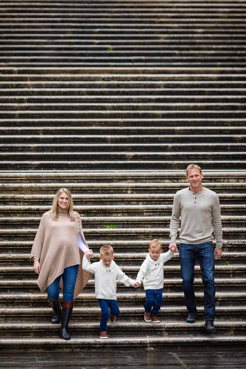 Holding hands and descending staircase during a photography session