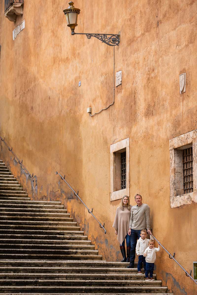 Posed photograph in a typical roman staircase with the group lined up on steps