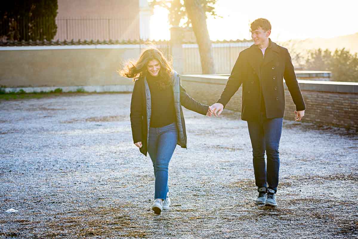 Walking together after asking the big engagement question during a photography session hand in hand