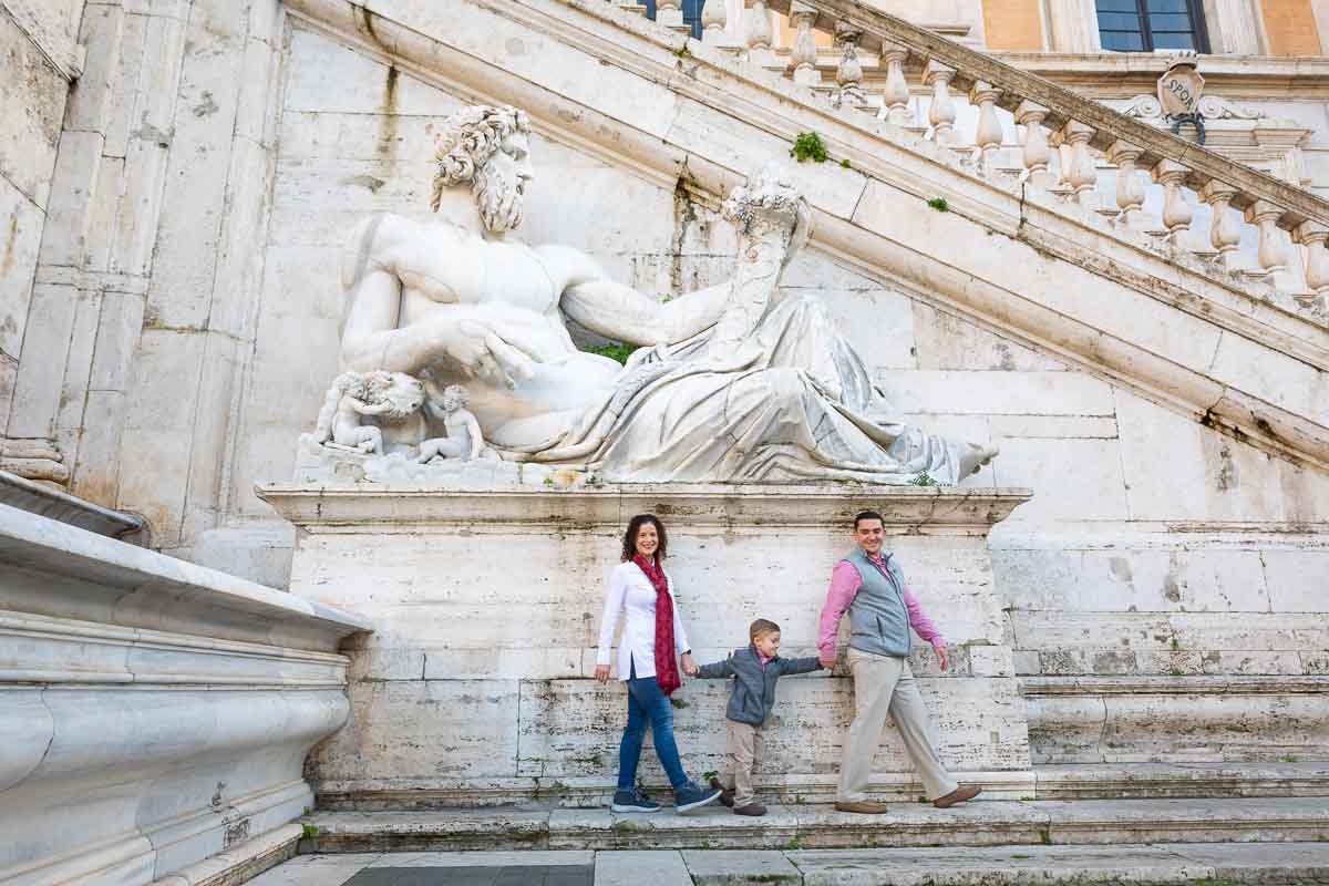 Walking under a large roman white marble statue