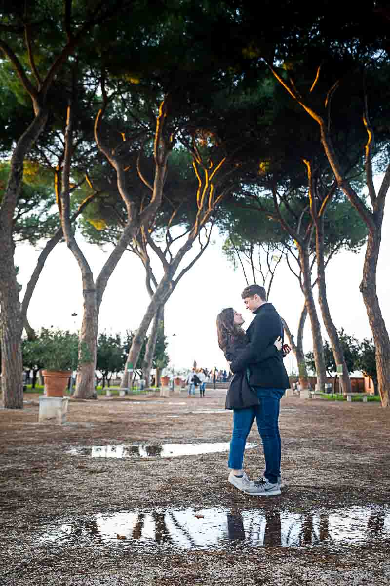 Standing posing for a photograph underneath the tall mediterranean pine trees found at the Orange garden