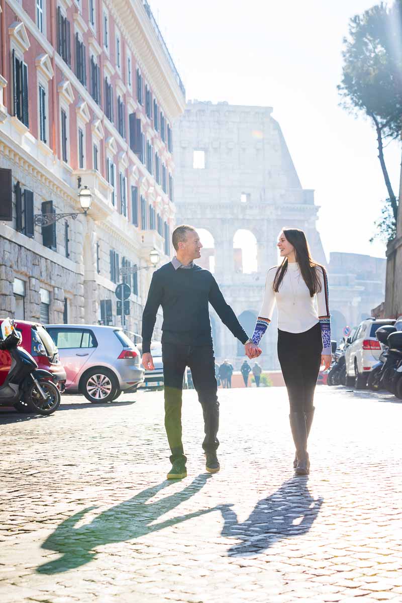 Walking together holding each other's hand with the iconic roman colosseum in the background