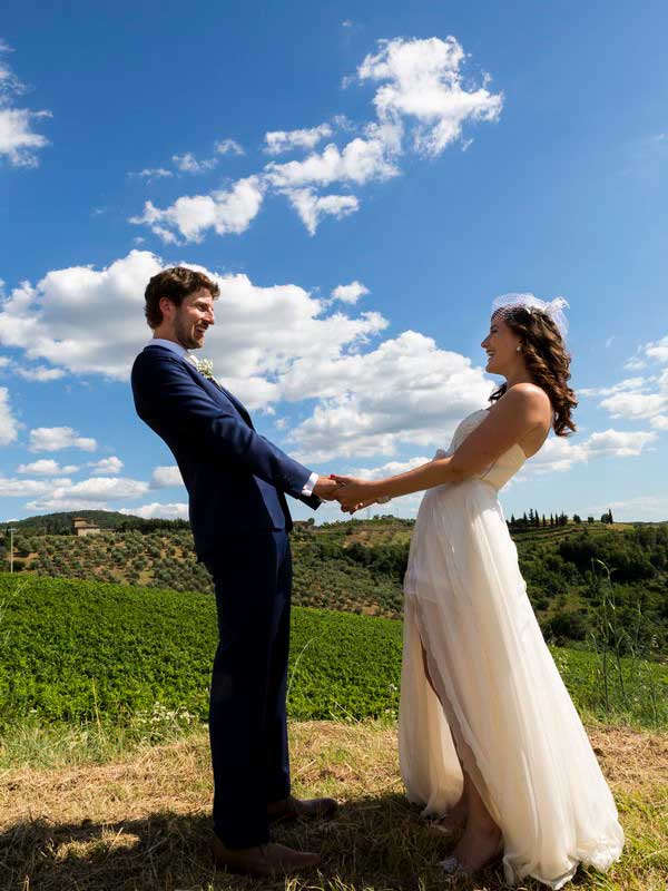 1-tuscany-wedding-photography Newlywed holding hands together during a wedding photo shoot in Tuscany Italy