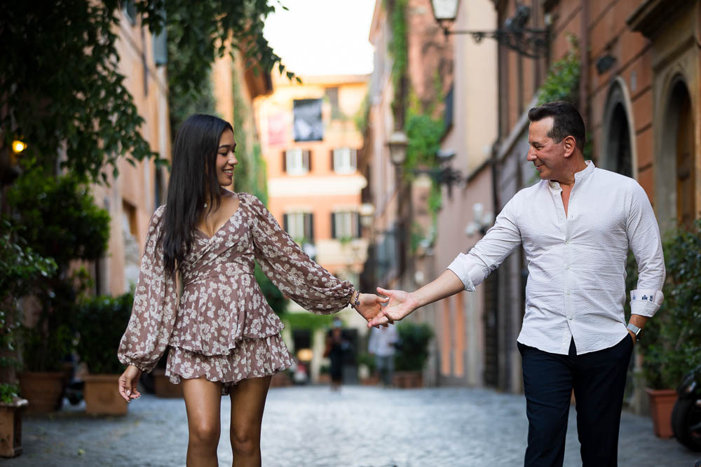 Walking holding hands in the cobblestone alleyways in Via Margutta during a photoshoot together