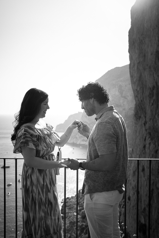 Chivalry moment photographed in black and white with beautiful seaside views. Black and white photography with professional photographers 