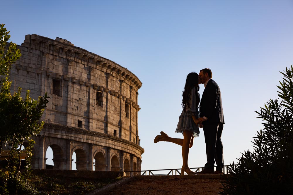Silhouette picture of a couple kissing before the Colosseum in the ancient city of Rome Italy