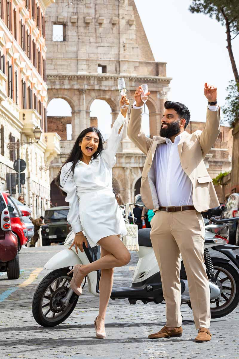 Just engaged couple celebrating together with hands in the air