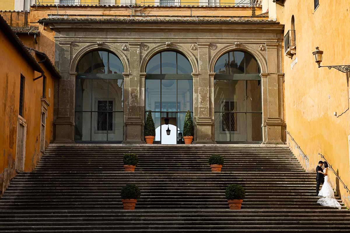 Artistic image of bride with groom taken on scenic staircase found in Piazza del Campidoglio