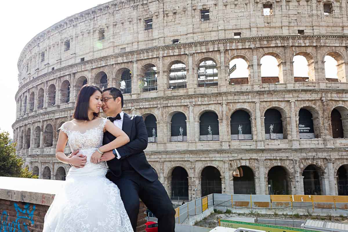 Bride & groom taking pictures Coliseum in Italy