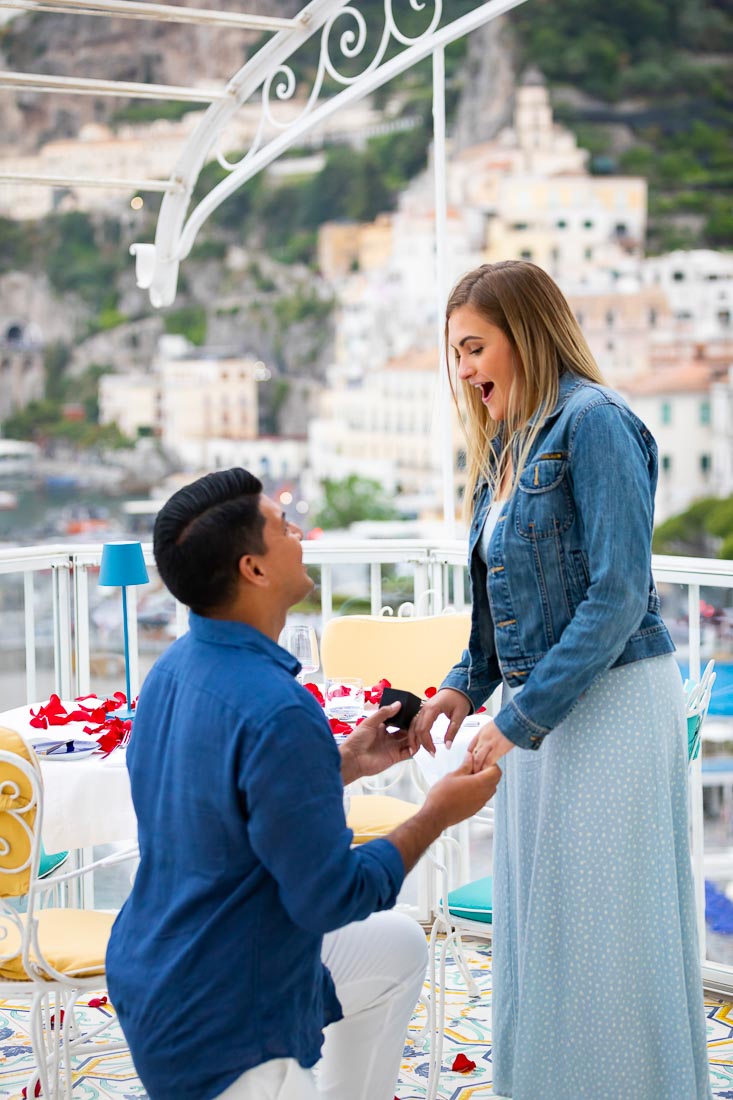 Wedding engagement surprised by asking the big question overlooking the city from above terrace where he proposed