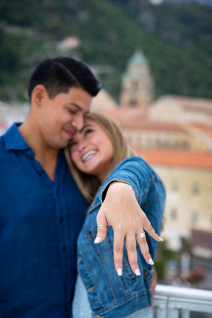 Showing off the engagement ring while on vacation and shooting pictures for couple photo shoot