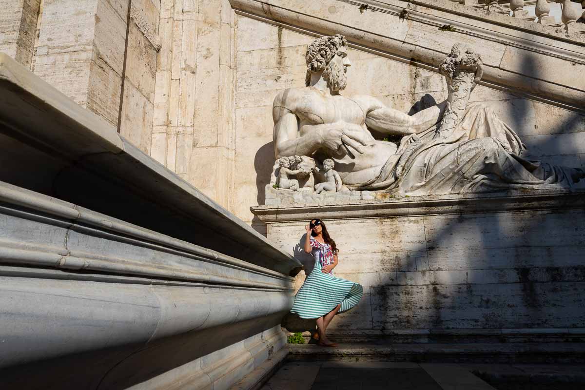 Creative and unique portrait picture of a photography model photographed under a marble statue