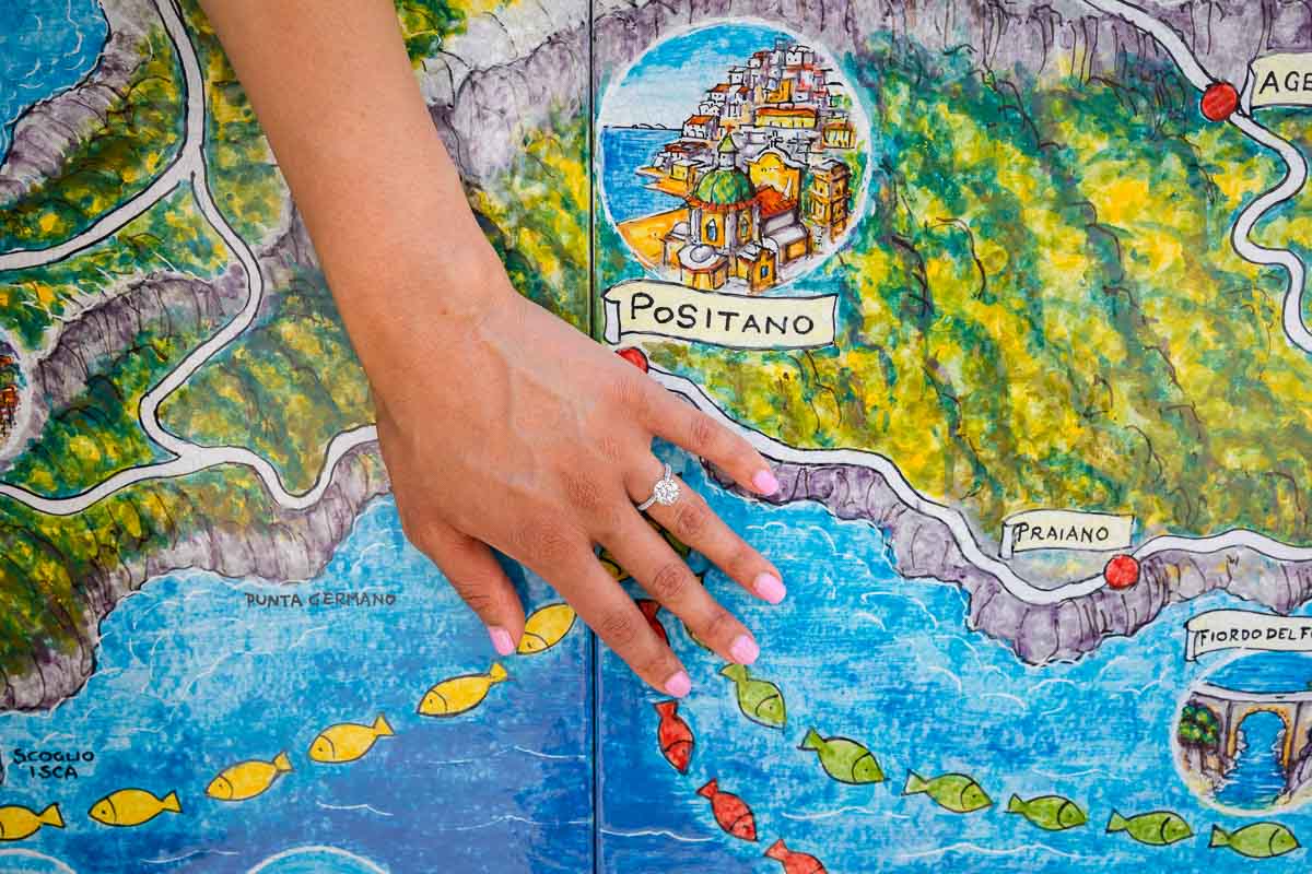 Wedding promise engagement ring photos taken over the map of the coast