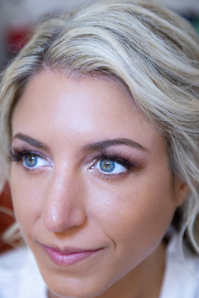 Bride portrait close up during the hairstyling phase of the wedding preparation