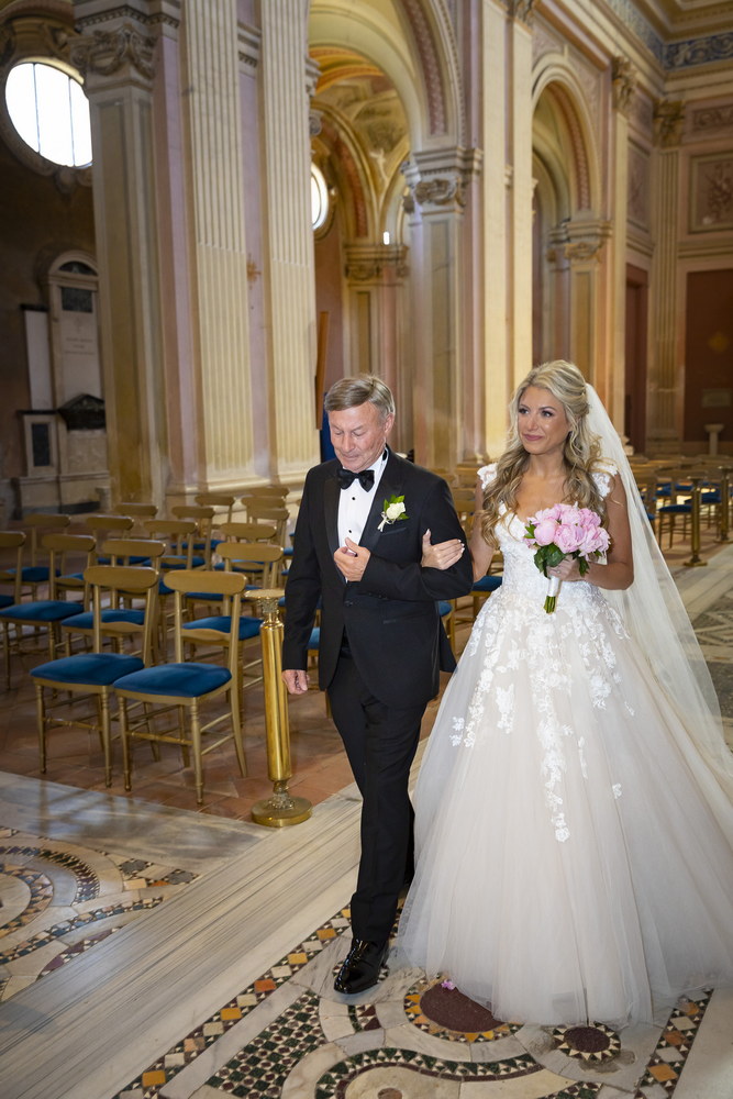 The father walking up the bride to get married