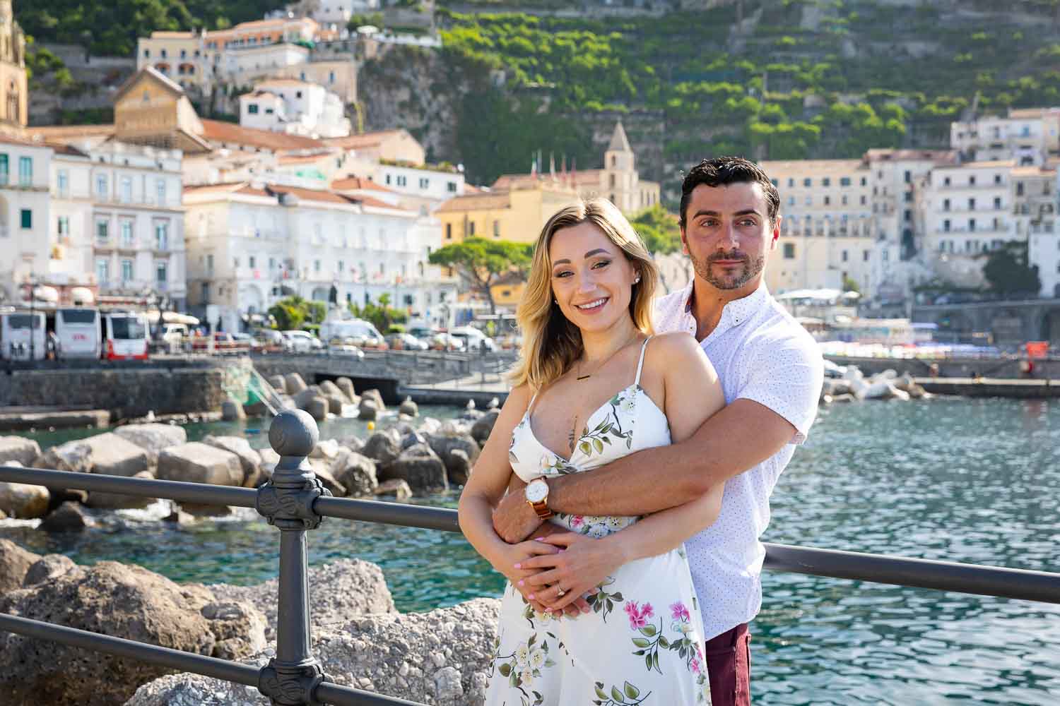 Engagement photoshoot portrait close together in front of sea 