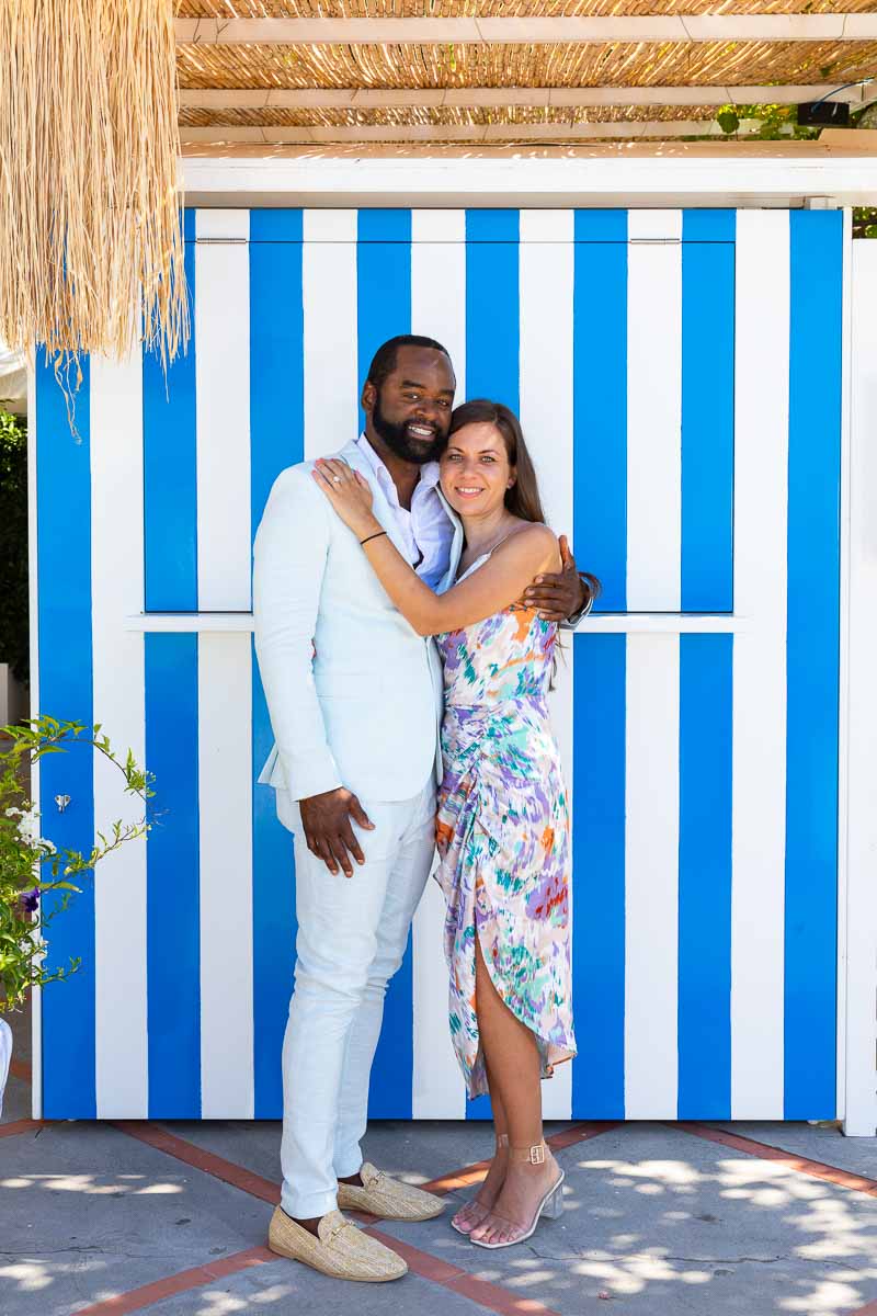 Couple portrait against blue and white changing cabins so typical area