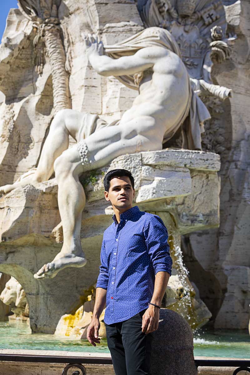 Looking sideways. Posing under a statue found on the fountain of the four rivers