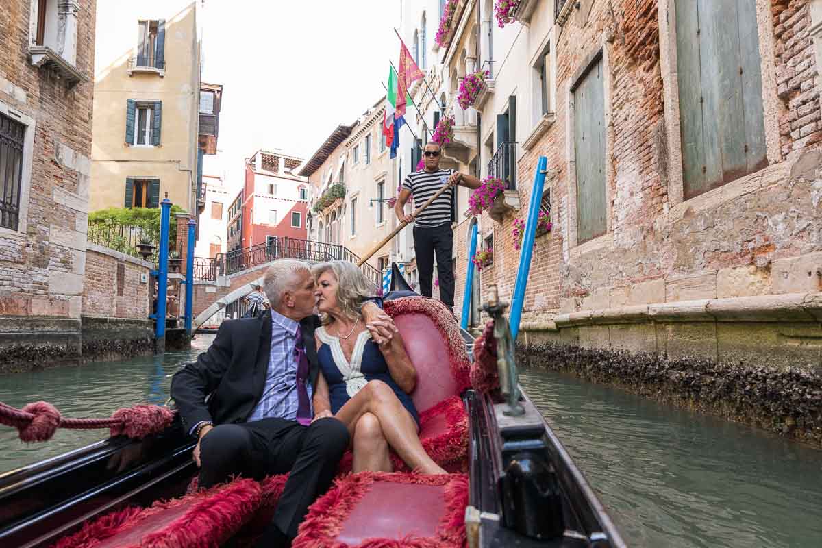 Just engaged image taken by a photographer from inside the gondola during and Italian gondola ride in Venice Italy